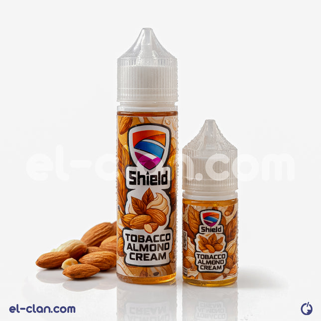 قنينة فيب ليكويد Shield e-juice بنكهة توباكو لوز كريمة، عبوة واضحة مع تصميم أنيق وزجاجة مميزة.
