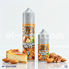 نفس الصورة تظهر علبة فيب ليكويد محلي بنكهة تشيز كيك مكسرات من XO E-Liquid، مع عبوة زجاجية وملصق ملون.